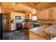 Kitchen with wood cabinets, granite counters, and black appliances at 3900 W Landberg Ave, Las Vegas, NV 89141