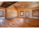 Spacious living room with wood walls, hardwood floors, and a ceiling fan at 3900 W Landberg Ave, Las Vegas, NV 89141