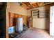 Unfinished utility room with water tank, shelving and exposed pipes at 3900 W Landberg Ave, Las Vegas, NV 89141