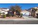 Single-story home with a two-car garage and landscaped front yard at 4030 Allyson Rae St, North Las Vegas, NV 89032