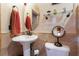 Elegant bathroom with pedestal sink and glass shelving at 4300 San Mateo St, North Las Vegas, NV 89032