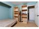 Bedroom with built-in shelving and access to bathroom at 4300 San Mateo St, North Las Vegas, NV 89032