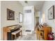 Bright entryway with tiled floor, two vintage organs, and framed artwork at 4773 Big Draw Dr, North Las Vegas, NV 89031