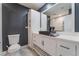 Modern bathroom with white vanity, black sink, and tile flooring at 4825 Greencreek Dr, Las Vegas, NV 89110