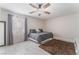 Spacious bedroom with gray bedding and tile floors at 4825 Greencreek Dr, Las Vegas, NV 89110