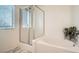 Bathroom with shower and tub, featuring a window at 4944 Guysborough St, Las Vegas, NV 89148