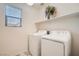 Laundry room with washer, dryer, and shelving at 4944 Guysborough St, Las Vegas, NV 89148