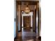 Hallway with wood flooring and chandelier at 5 Promontory Pointe Ln, Las Vegas, NV 89135