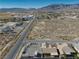 Property view showing home, road and surrounding desert landscape at 5001 Ray Frank Blvd, Pahrump, NV 89060