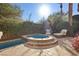 Secluded backyard oasis with a hot tub, serene lounge area, and lush landscaping for ultimate relaxation at 51 Avenida Sorrento, Henderson, NV 89011