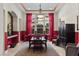 Elegant dining room featuring stylish lighting, wainscoting, and large windows with vibrant red curtains at 51 Avenida Sorrento, Henderson, NV 89011