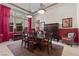 An elegant dining area boasting large windows, eye-catching red accents, and a charming area rug at 51 Avenida Sorrento, Henderson, NV 89011