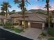 Beautiful single-story home featuring a tile roof, desert landscaping, and a paved driveway at 51 Avenida Sorrento, Henderson, NV 89011