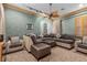 Cozy living room with plush sectional, neutral color palette, and shuttered window at 51 Avenida Sorrento, Henderson, NV 89011