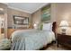 Relaxing bedroom with a king bed, soft lighting, and a view into the ensuite bathroom at 51 Avenida Sorrento, Henderson, NV 89011