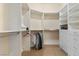 Bright walk-in closet with custom shelving, hanging rods, and carpeted floor at 51 Avenida Sorrento, Henderson, NV 89011