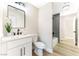 Modern bathroom with white vanity, marble countertop, and gray tile shower at 5153 Woodruff Pl, Las Vegas, NV 89120