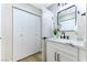 Modern bathroom with white vanity, marble countertop, and large mirror at 5153 Woodruff Pl, Las Vegas, NV 89120