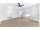 Large bedroom with ceiling fan, carpet flooring, and access to another room at 5153 Woodruff Pl, Las Vegas, NV 89120