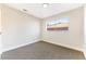 Bright bedroom with neutral walls, carpet, and a window offering natural light at 5153 Woodruff Pl, Las Vegas, NV 89120