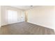 Well-lit bedroom featuring neutral walls and carpet, plus a large closet at 5153 Woodruff Pl, Las Vegas, NV 89120