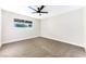 Well-lit bedroom featuring a ceiling fan, carpet flooring, and large window at 5153 Woodruff Pl, Las Vegas, NV 89120