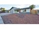 Newly renovated home with gray garage door and red front door at 5153 Woodruff Pl, Las Vegas, NV 89120