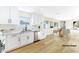 Modern white kitchen with quartz countertops and stainless steel appliances at 5153 Woodruff Pl, Las Vegas, NV 89120