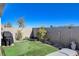 This backyard features low-maintenance landscaping, artificial turf and a BBQ grill at 6 Lilla Rosa St, Henderson, NV 89011