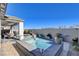 The backyard has an in-ground pool, spa, patio, and lush landscaping at 6 Lilla Rosa St, Henderson, NV 89011