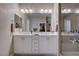 Bathroom featuring a double vanity sink, shower with glass door, and walk-in closet at 6 Lilla Rosa St, Henderson, NV 89011