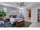 Bedroom features a ceiling fan, rug, a wood chest, and a blue sofa at 6 Lilla Rosa St, Henderson, NV 89011