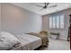 Bedroom with ceiling fan, carpet, and window with shutters at 6 Lilla Rosa St, Henderson, NV 89011