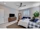 Bedroom featuring a large wall mirror, ceiling fan, dresser, and a sitting area at 6 Lilla Rosa St, Henderson, NV 89011