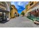 Charming street with colorful buildings, lush greenery, and inviting shops under a bright, partly cloudy sky at 6 Lilla Rosa St, Henderson, NV 89011