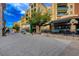 Scenic street view with outdoor dining, stylish storefronts, and beautiful landscaping along a brick-paved road at 6 Lilla Rosa St, Henderson, NV 89011