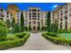 Luxury apartment building with lush landscaping, manicured lawn and decorative trellises at 6 Lilla Rosa St, Henderson, NV 89011