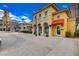 Retail shops with lovely yellow paint and awnings line this quaint brick-paved street at 6 Lilla Rosa St, Henderson, NV 89011