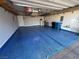 Spacious garage featuring an epoxy floor, storage racks, and ample room for vehicles at 6 Lilla Rosa St, Henderson, NV 89011