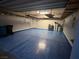 Spacious garage featuring epoxy flooring, overhead storage racks, and ample room for vehicles and storage at 6 Lilla Rosa St, Henderson, NV 89011