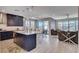 Open concept kitchen with navy cabinets, large island, and seamless flow into living and dining areas at 6 Lilla Rosa St, Henderson, NV 89011