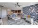 Open-concept living room with modern decor, leading into the kitchen and dining area at 6 Lilla Rosa St, Henderson, NV 89011