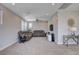 Loft living area features a ceiling fan, large windows, neutral walls, and plush carpet at 6 Lilla Rosa St, Henderson, NV 89011