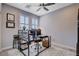 Bright home office with neutral colors, shutters, and a ceiling fan at 6 Lilla Rosa St, Henderson, NV 89011