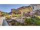 Outdoor picnic area with covered seating, lush greenery, and a paved walkway at 6 Lilla Rosa St, Henderson, NV 89011