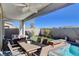 This outdoor space features a pool, spa, seating, and a well-manicured artificial lawn at 6 Lilla Rosa St, Henderson, NV 89011