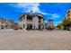 Elegant two-story building with outdoor seating, complemented by charming architectural details and lush greenery at 6 Lilla Rosa St, Henderson, NV 89011