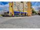 Outdoor restaurant seating area with blue umbrellas and nicely paved walkway, with large building at 6 Lilla Rosa St, Henderson, NV 89011