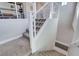 Second story carpeted staircase with white banister and metal railing at 6 Lilla Rosa St, Henderson, NV 89011