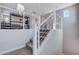 Second story carpeted staircase with white banister and metal railing at 6 Lilla Rosa St, Henderson, NV 89011